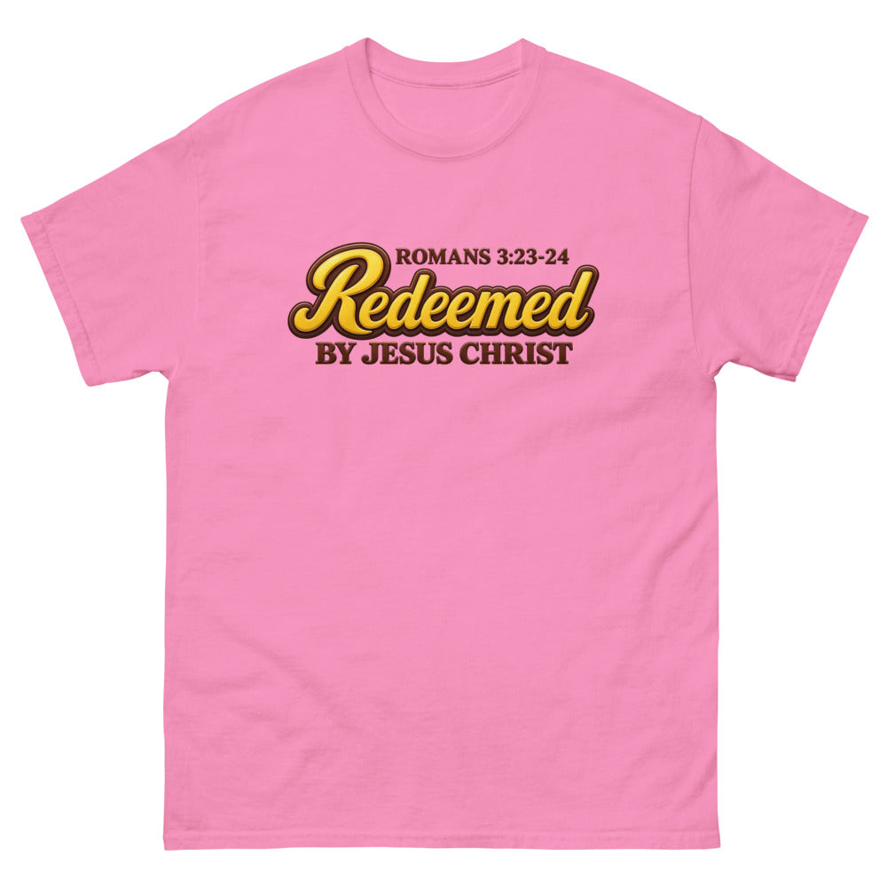 Glossy gold and brown candy script reading Redeemed by Jesus Christ, Romans 3:23-24 on a Azalea shirt