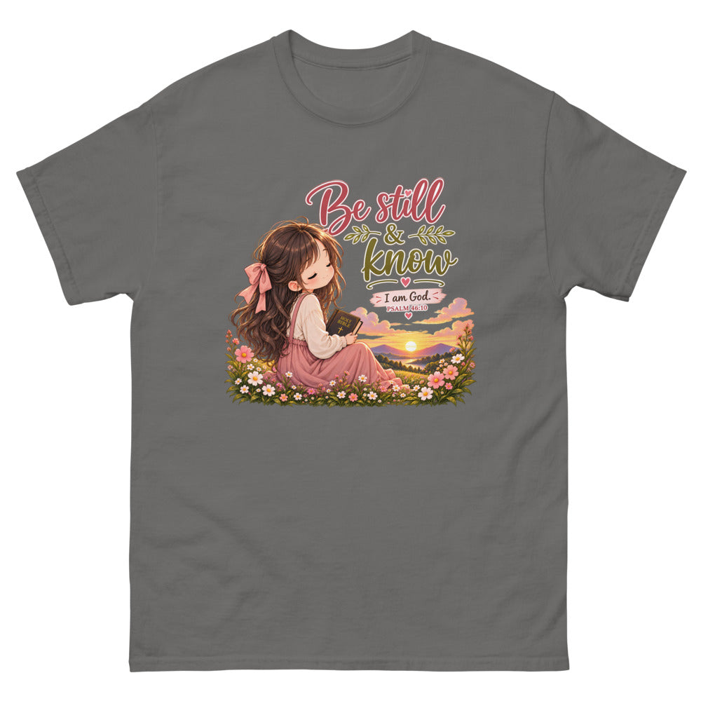 Chibi girl in a flower field holding a Bible with the words Be Still And Know on a Charcoal shirt