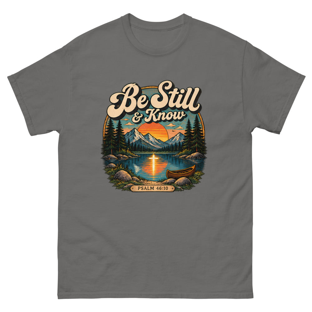 Retro lake and canoe scene at sunset reading Be Still And Know on a Charcoal shirt