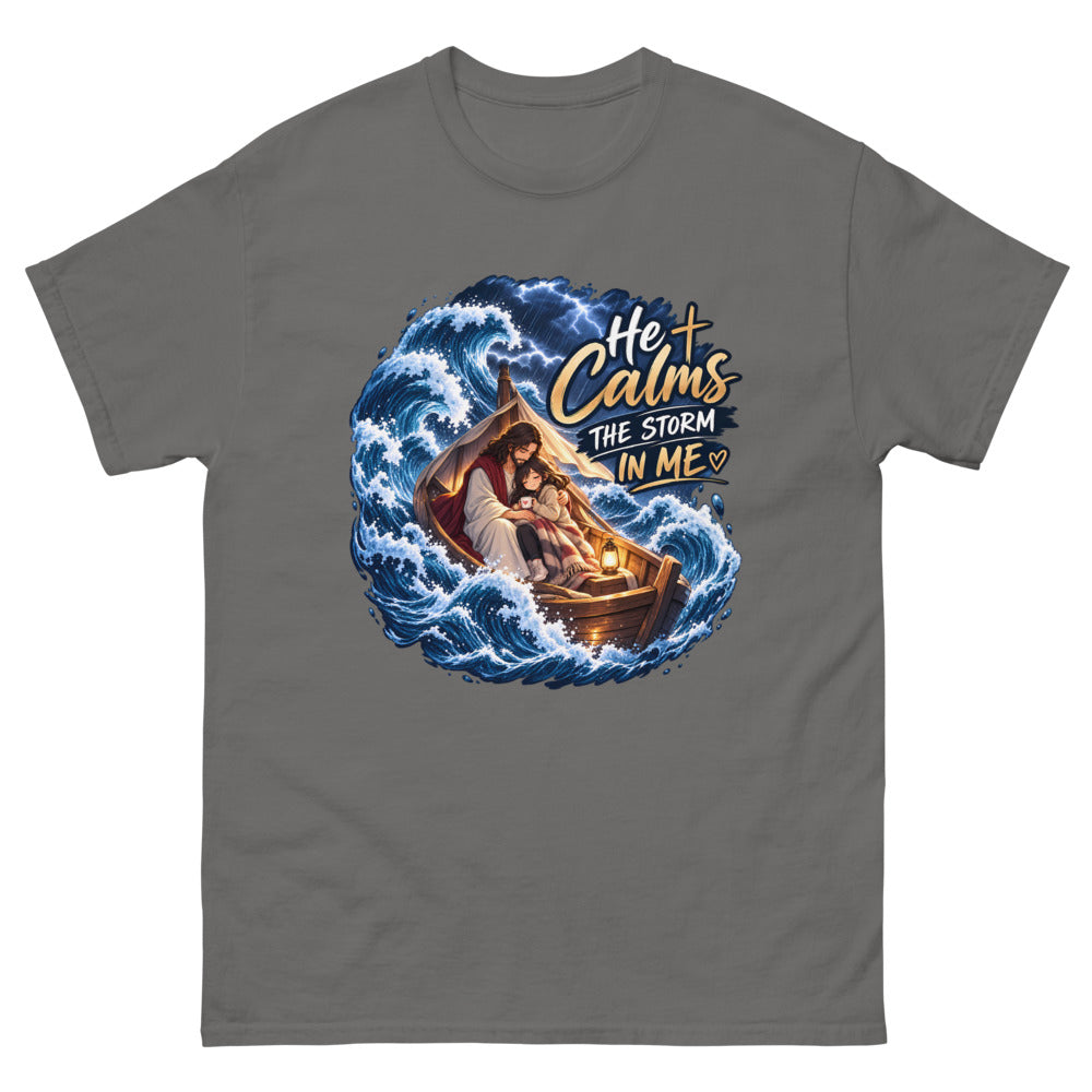 Jesus holding a young woman in a boat during a storm with the words He Calms The Storm In Me on a Charcoal shirt