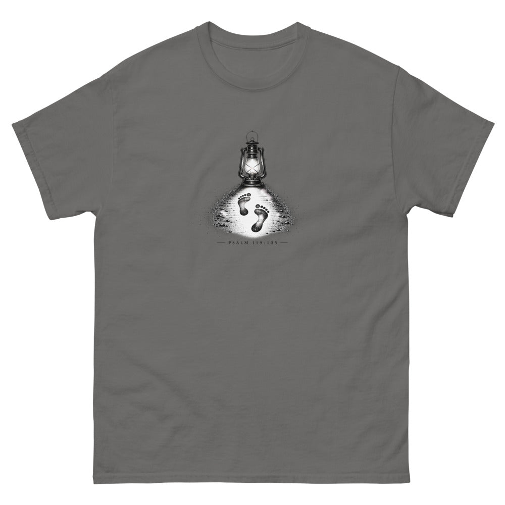 Stippled lantern lighting two footprints in sand with Psalm 119:105 on a Charcoal shirt