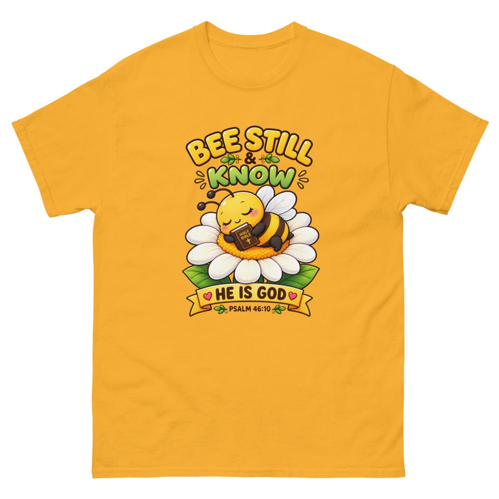 Cartoon bee sleeping on a daisy with a Bible and the words Bee Still And Know on a Gold shirt