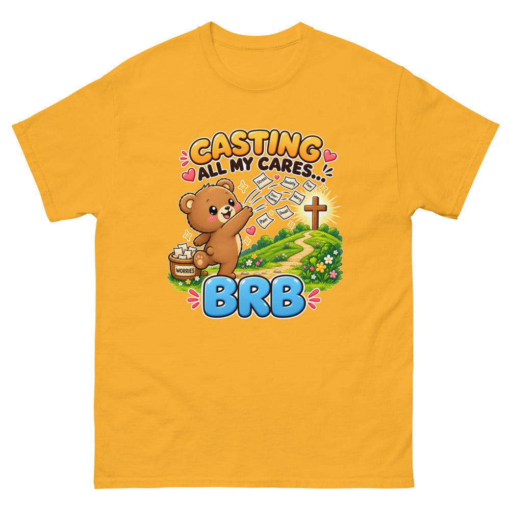 Cartoon bear throwing worry notes away with the words Casting All My Cares BRB on a Gold shirt
