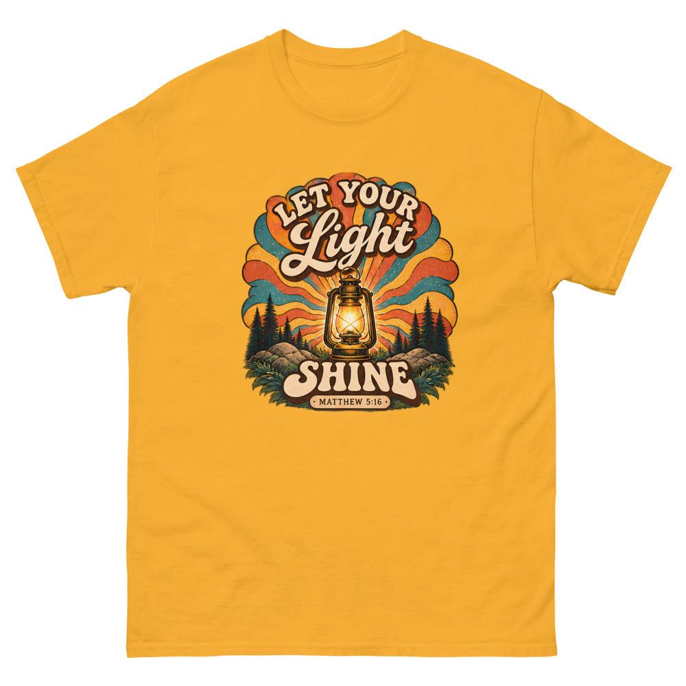Retro lantern glowing against sunburst rays reading Let Your Light Shine on a Gold shirt