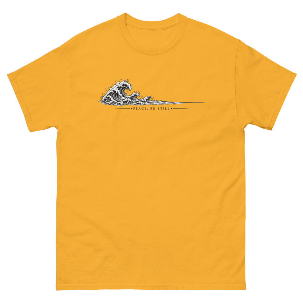 Engraved line art wave with the words Peace Be Still on a Gold shirt