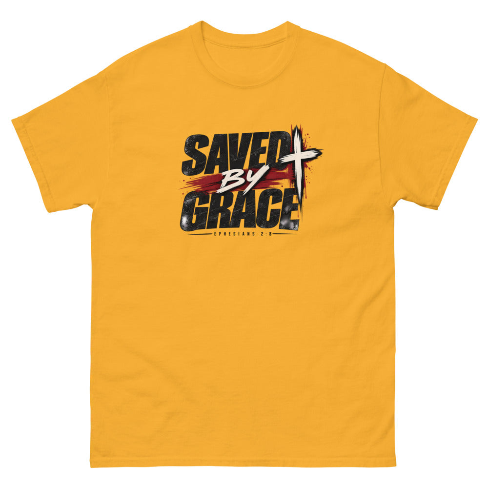 Streetwear lettering with a red brush stroke and cross reading Saved By Grace on a Gold shirt