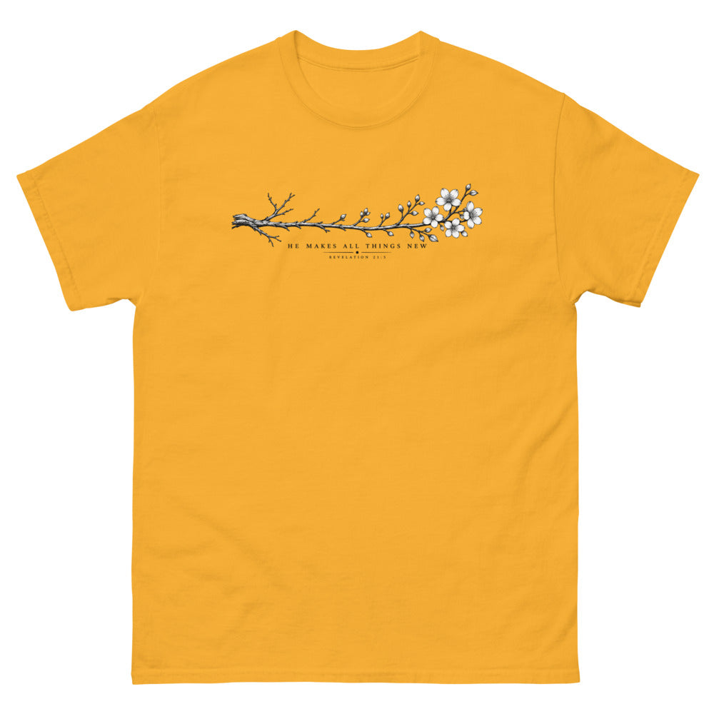 Line art branch flowering from bare to bloom with the words He Makes All Things New on a Gold shirt