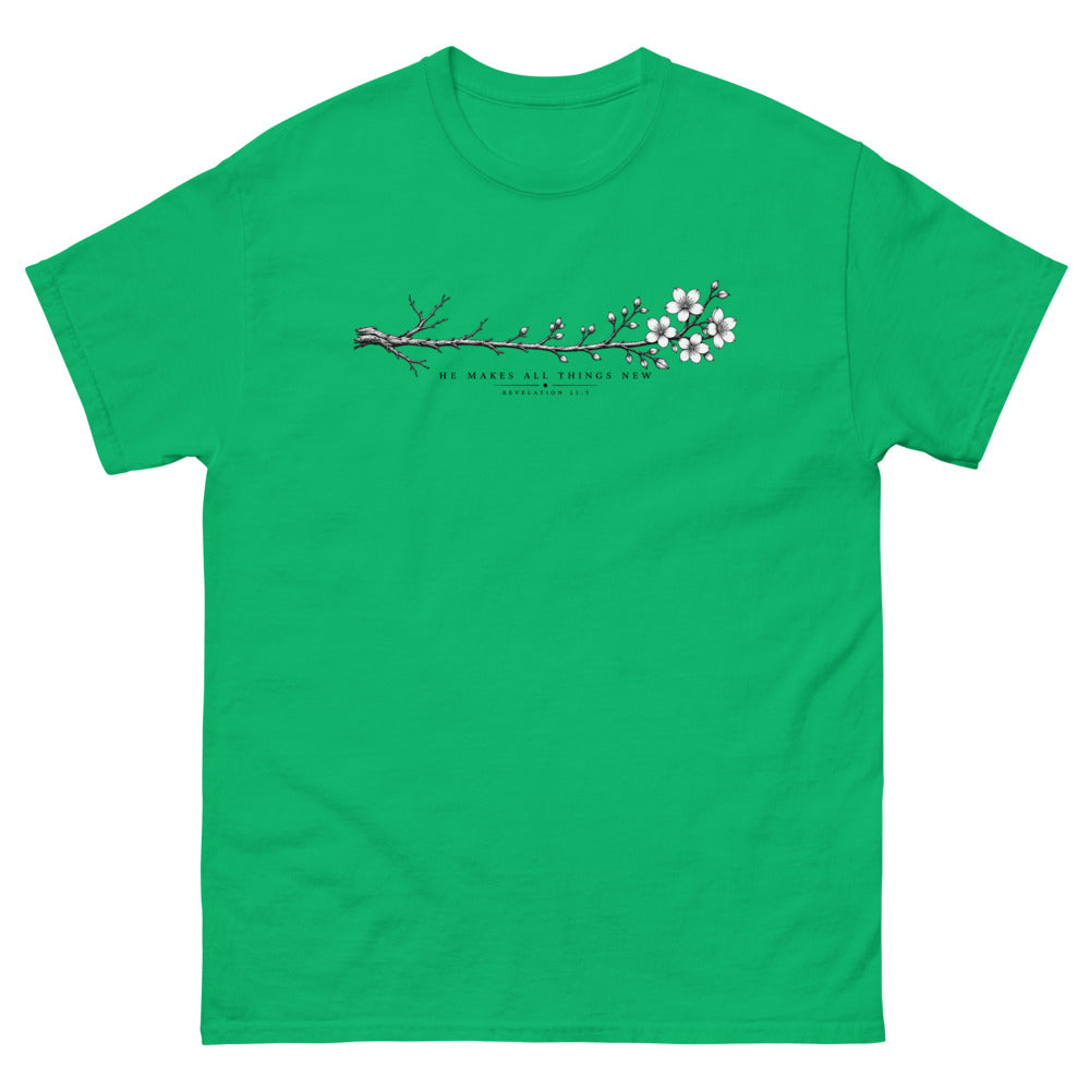 Line art branch flowering from bare to bloom with the words He Makes All Things New on a Irish Green shirt
