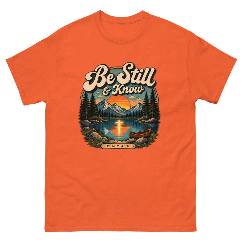 Retro lake and canoe scene at sunset reading Be Still And Know on a Orange shirt