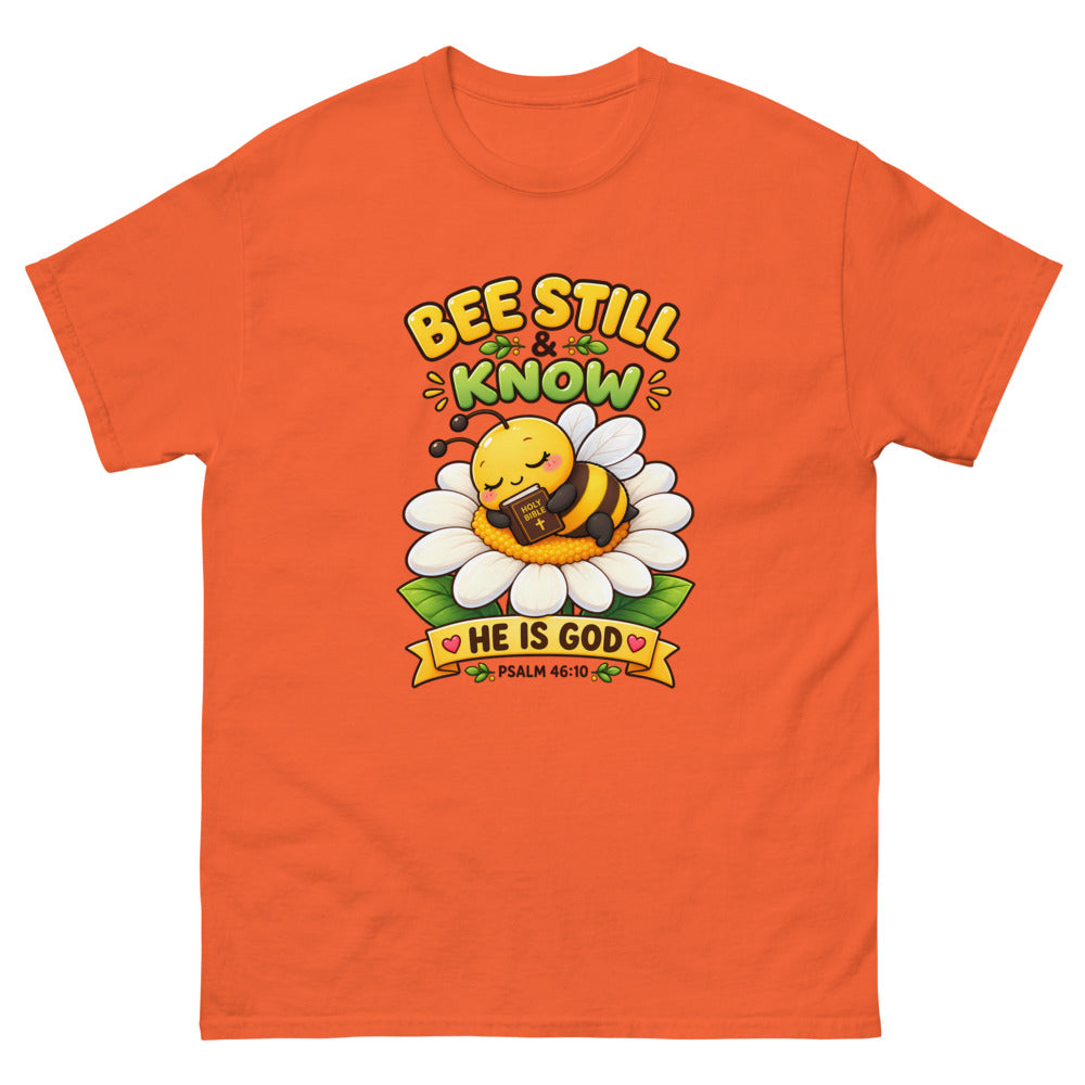 Cartoon bee sleeping on a daisy with a Bible and the words Bee Still And Know on a Orange shirt