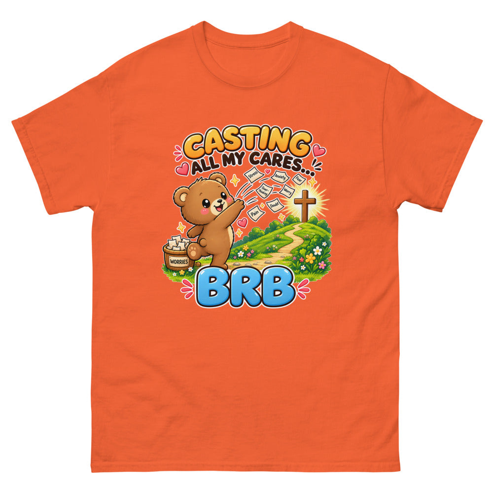 Cartoon bear throwing worry notes away with the words Casting All My Cares BRB on a Orange shirt