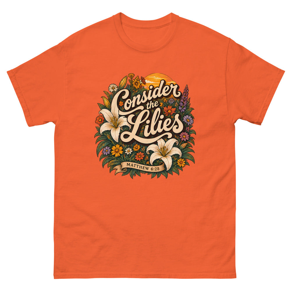 Retro floral illustration with lilies reading Consider The Lilies on a Orange shirt