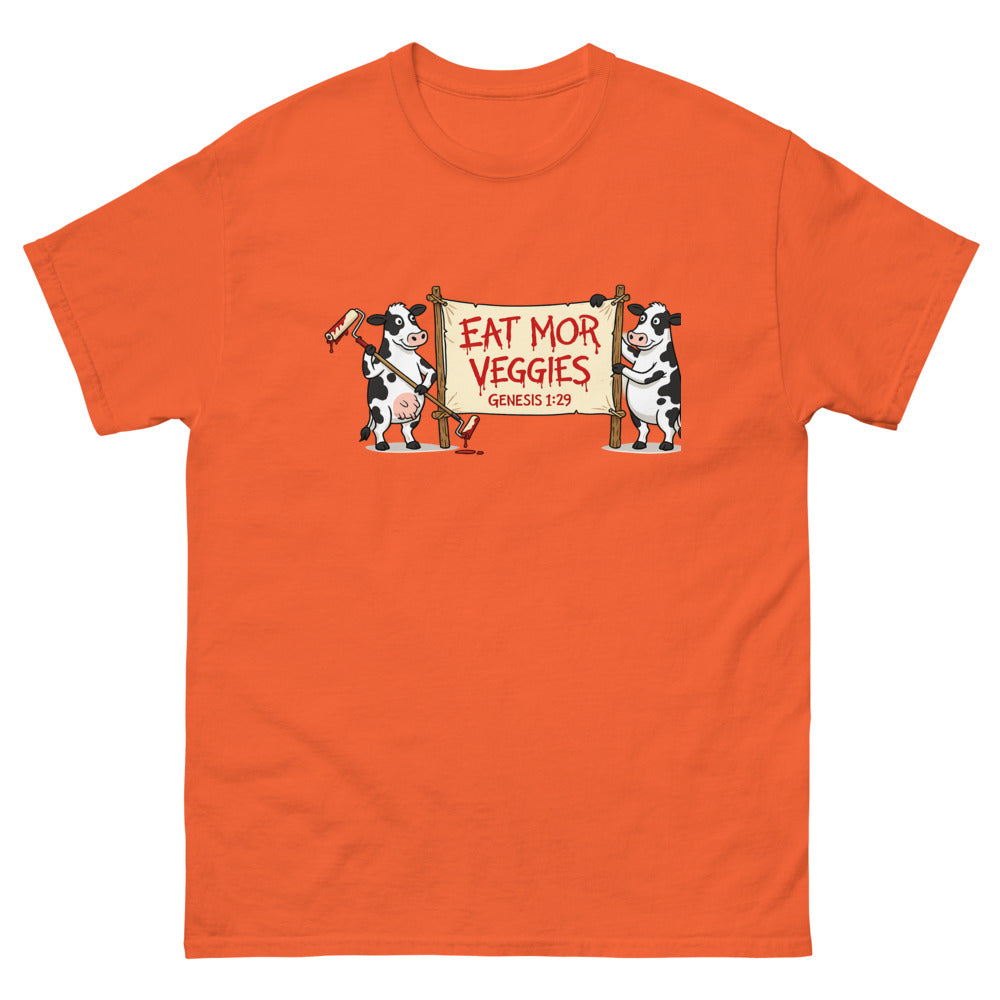 Two cartoon cows holding a banner reading Eat Mor Veggies, Genesis 1:29 on a Orange shirt