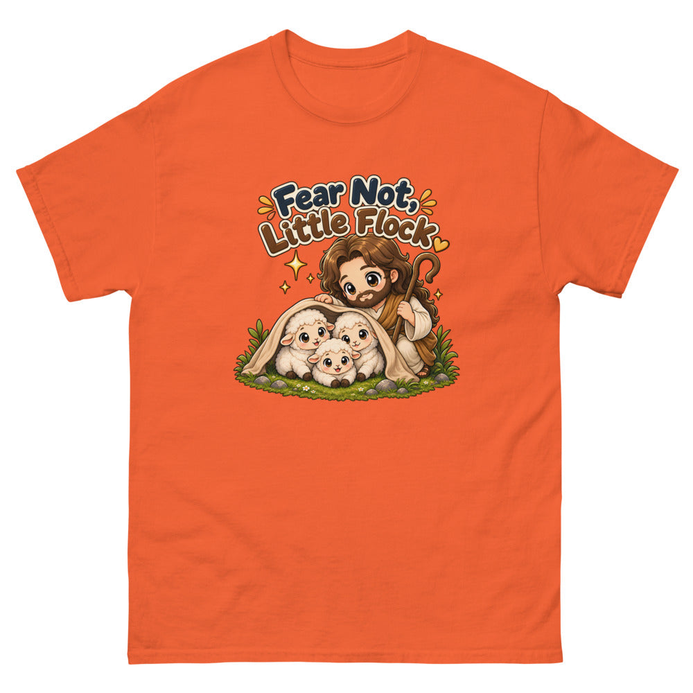 Chibi Jesus tucking a blanket around three sheep with the words Fear Not Little Flock on a Orange shirt
