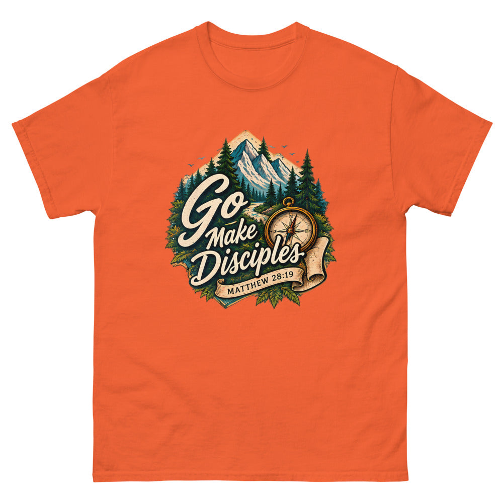 Compass over a mountain trail badge reading Go Make Disciples on a Orange shirt