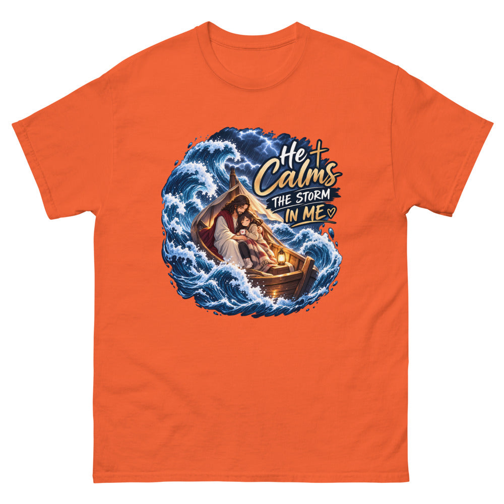 Jesus holding a young woman in a boat during a storm with the words He Calms The Storm In Me on a Orange shirt