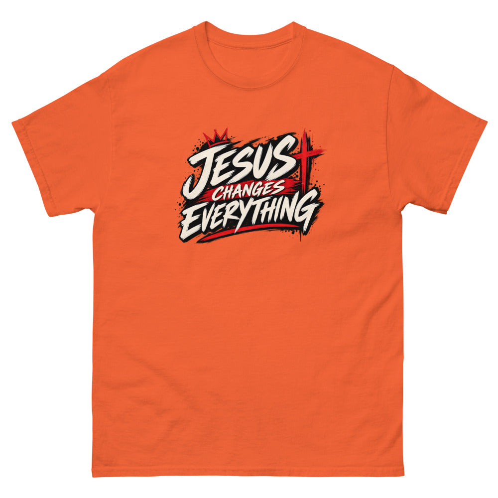 Brush script streetwear graphic with a crown and red cross reading Jesus Changes Everything on a Orange shirt