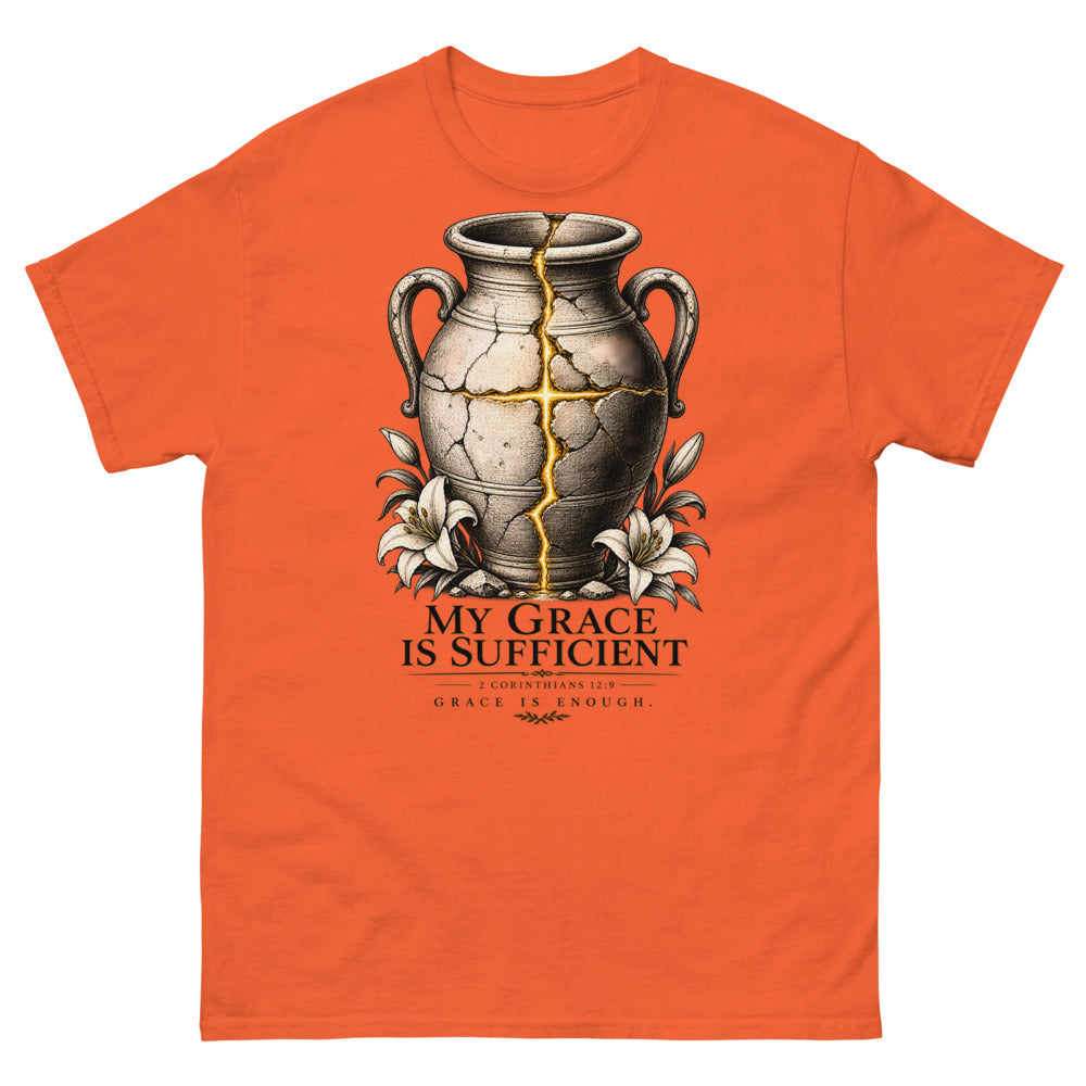 Cracked vessel repaired with gold seams forming a cross, reading My Grace Is Sufficient on a Orange shirt