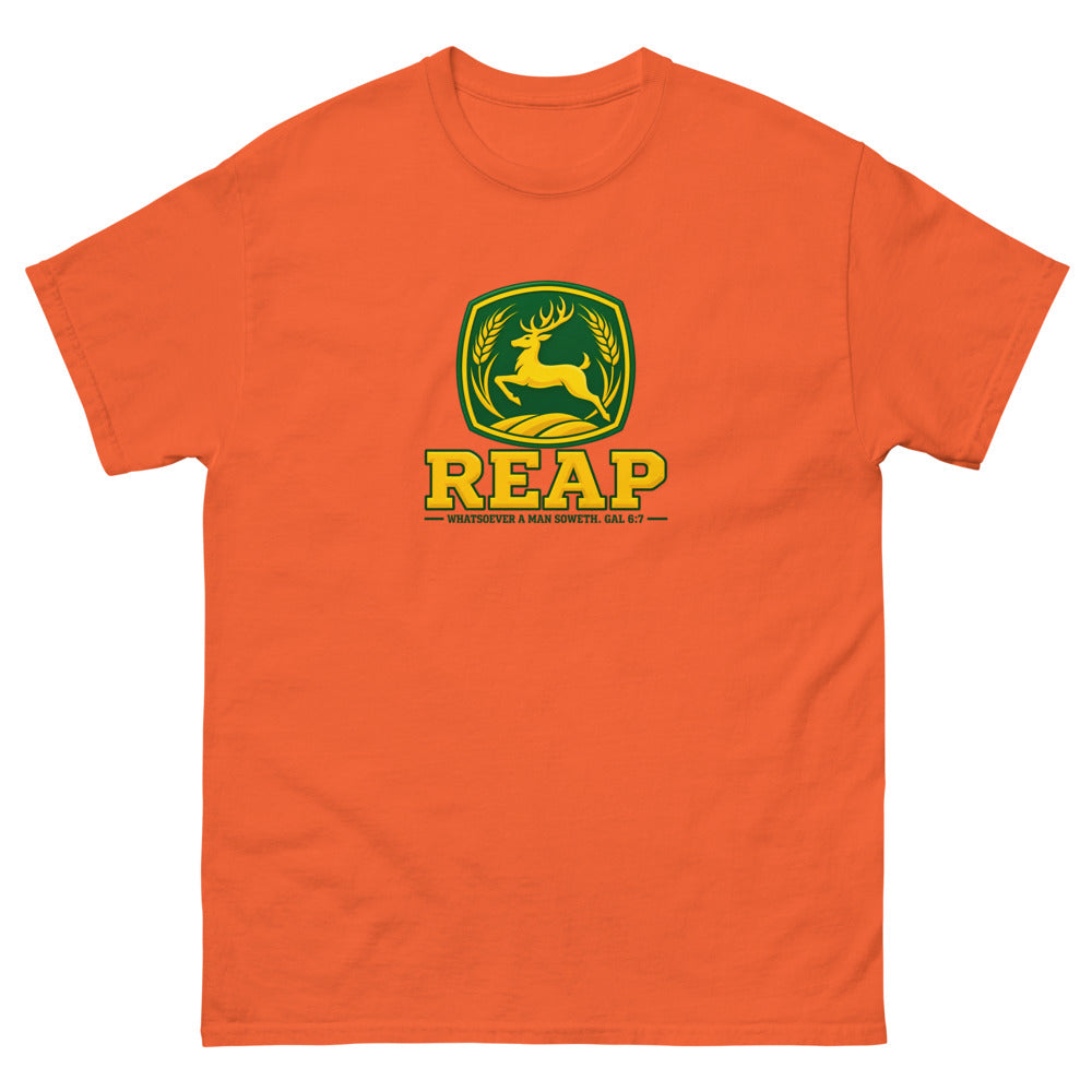 Green and gold crest with a leaping deer and wheat reading Reap, Galatians 6:7 on a Orange shirt