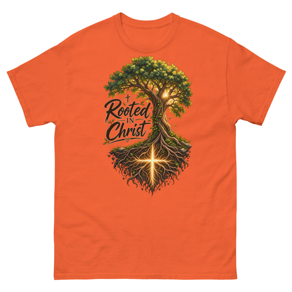 Detailed tree with a glowing cross in its roots and the words Rooted In Christ on a Orange shirt