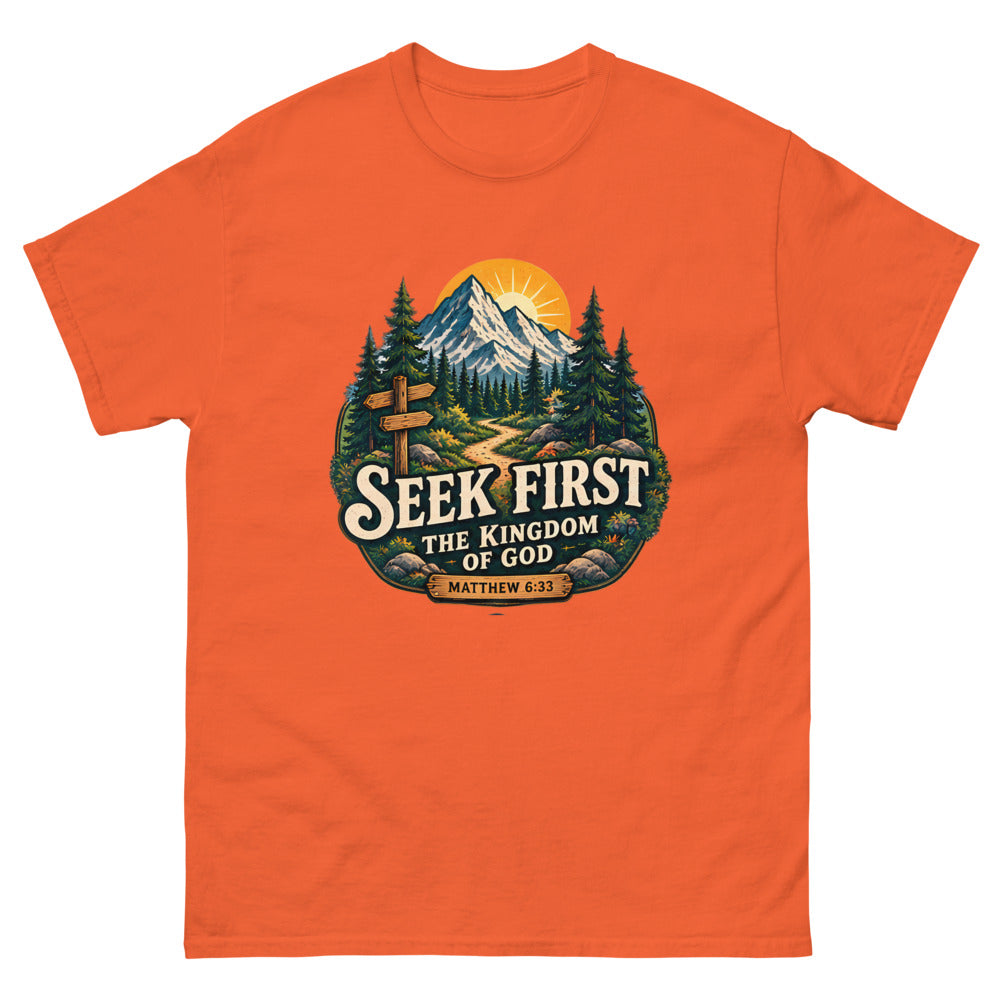 Vintage trail badge with mountains and a signpost reading Seek First The Kingdom Of God on a Orange shirt