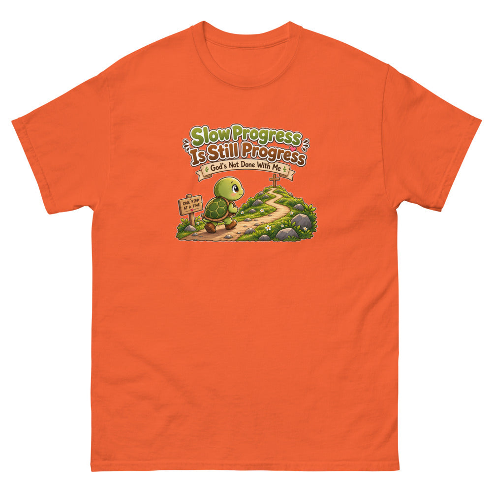 Cartoon turtle walking a path toward a cross with the words Slow Progress Is Still Progress on a Orange shirt