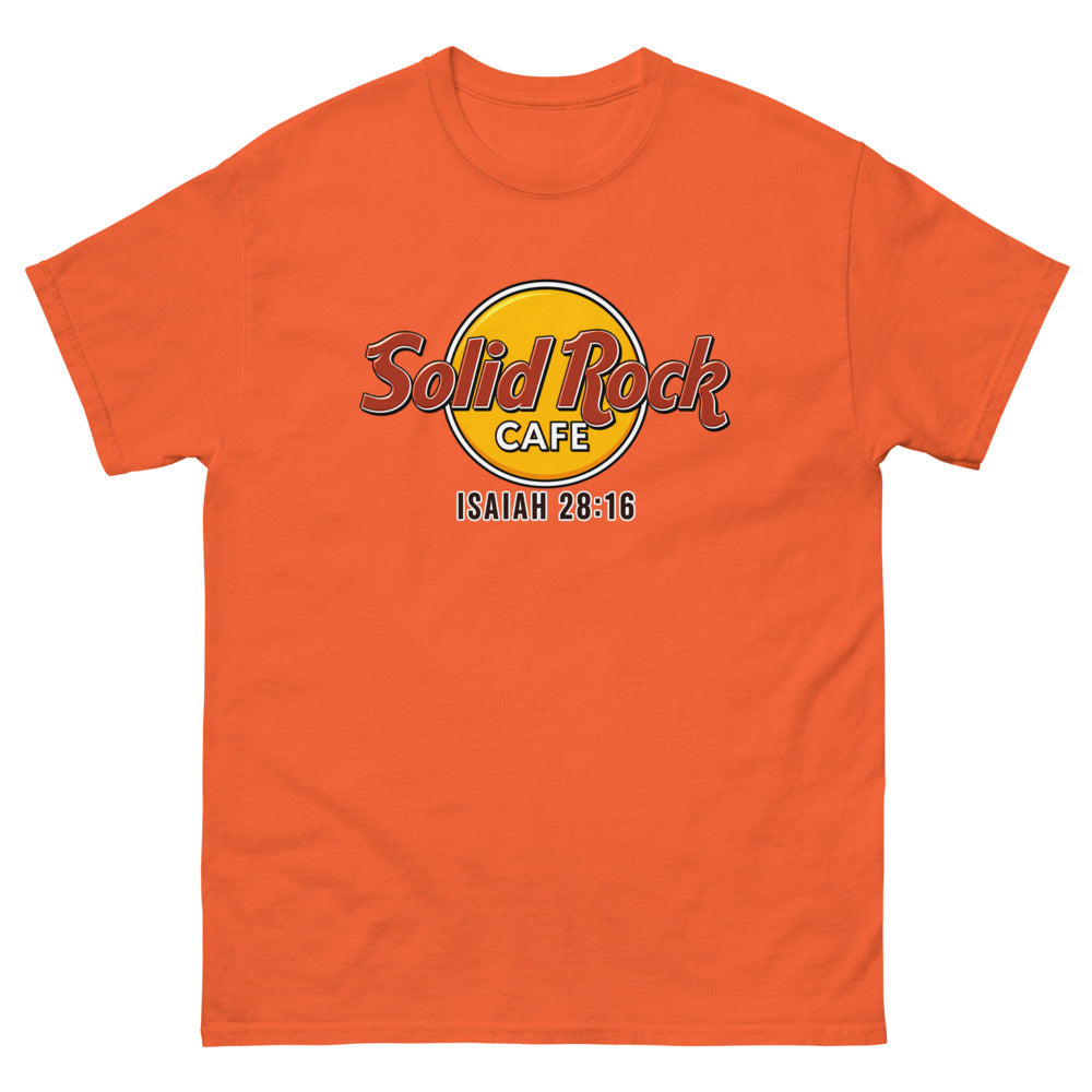 Gold roundel reading Solid Rock Cafe with Isaiah 28:16 on a Orange shirt