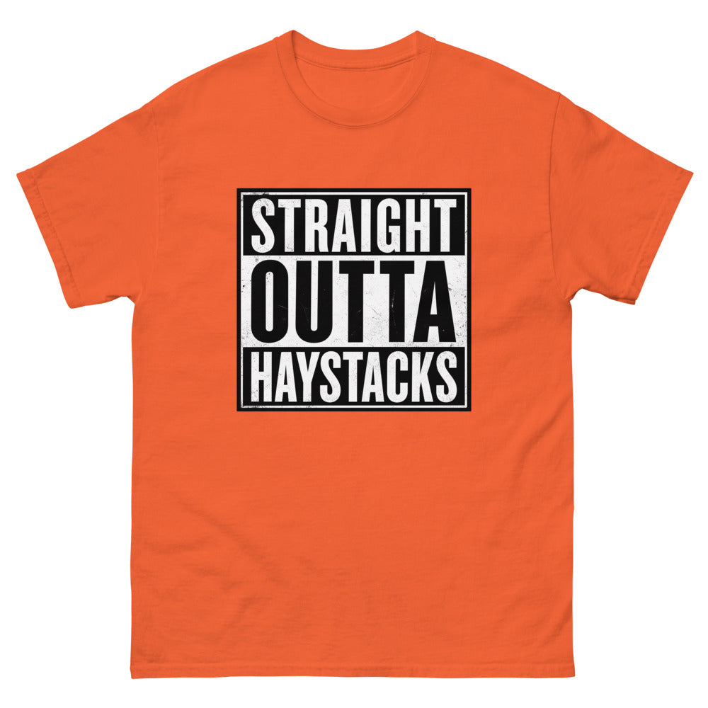 Distressed block lettering reading Straight Outta Haystacks on a Orange shirt
