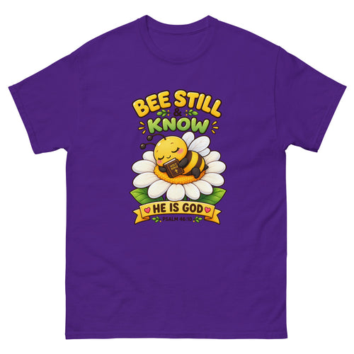 Cartoon bee sleeping on a daisy with a Bible and the words Bee Still And Know on a Purple shirt