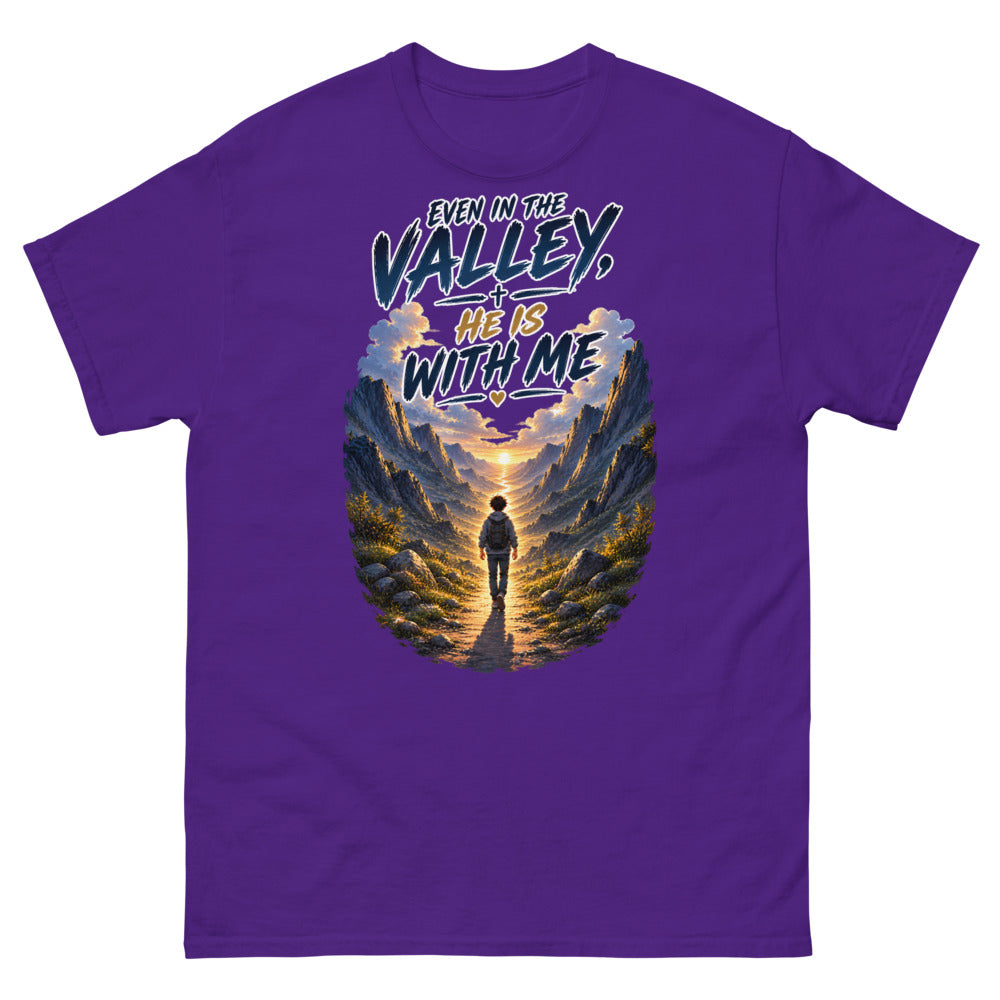 Hiker walking through a mountain valley with the words Even In The Valley He Is With Me on a Purple shirt