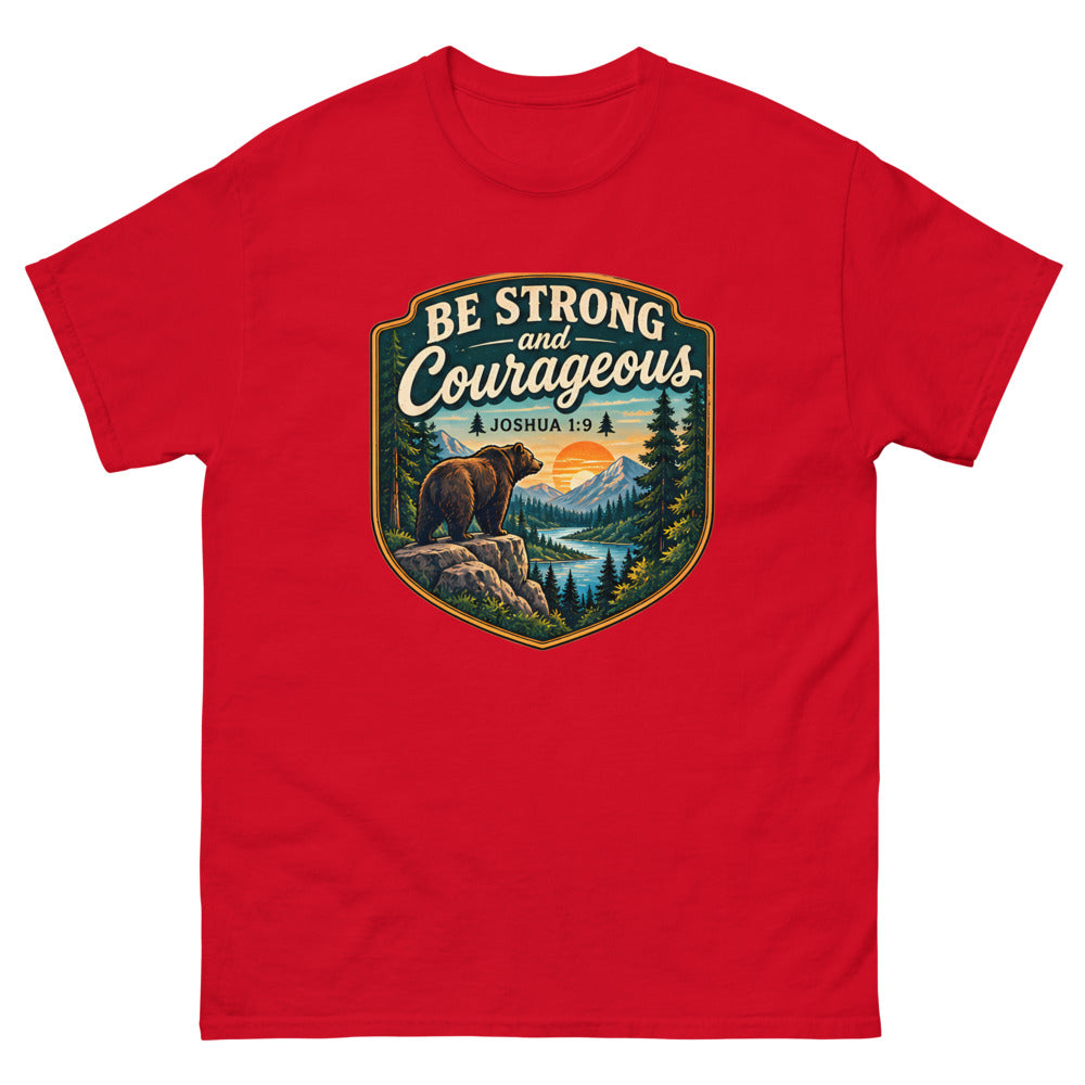 Shield badge with a bear on a rock reading Be Strong And Courageous on a Red shirt