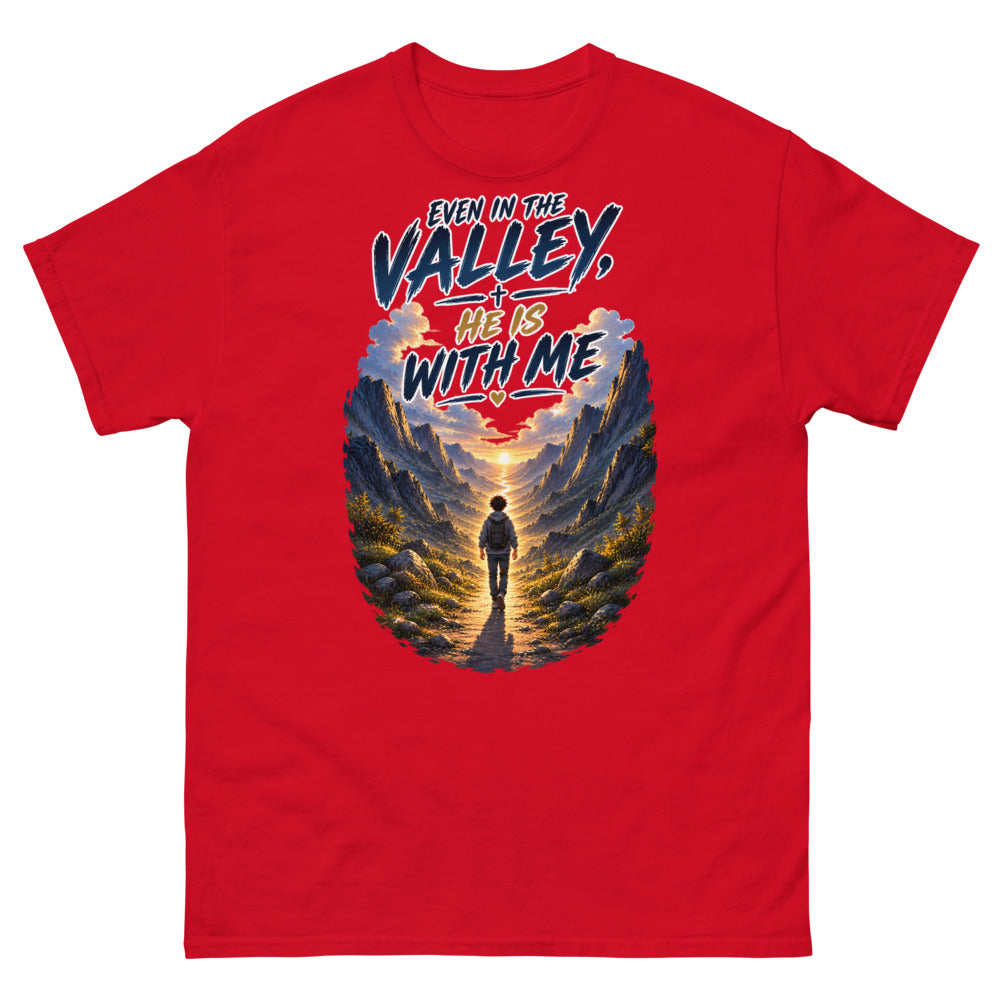 Hiker walking through a mountain valley with the words Even In The Valley He Is With Me on a Red shirt