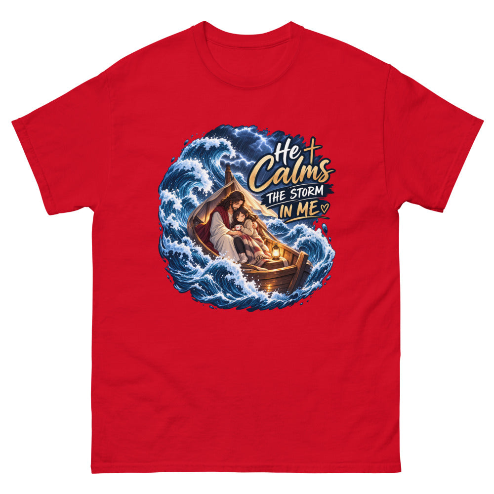 Jesus holding a young woman in a boat during a storm with the words He Calms The Storm In Me on a Red shirt
