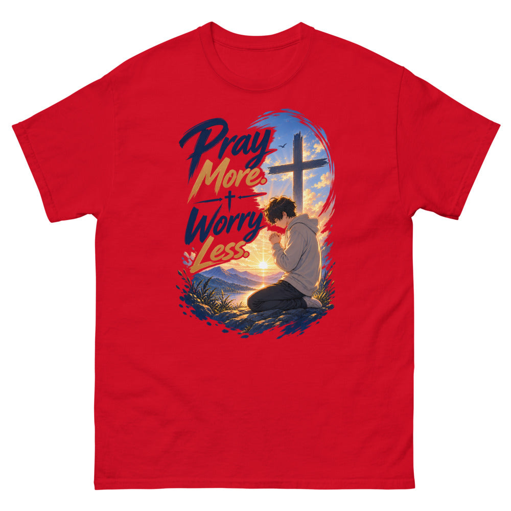 Anime boy kneeling in prayer at sunrise beneath a cross with the words Pray More Worry Less on a Red shirt