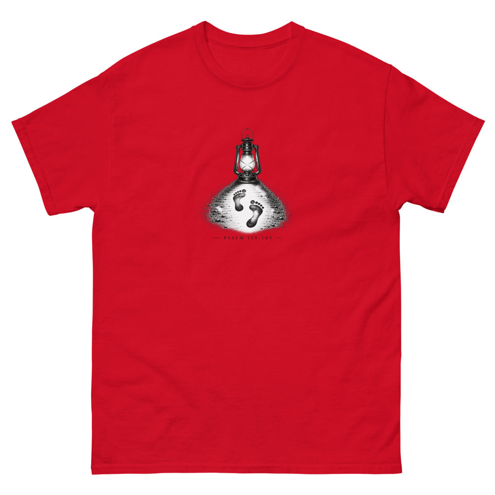 Stippled lantern lighting two footprints in sand with Psalm 119:105 on a Red shirt