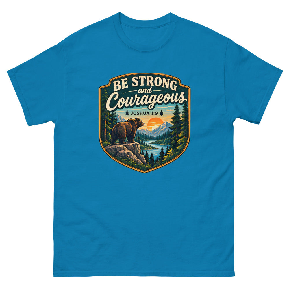 Shield badge with a bear on a rock reading Be Strong And Courageous on a Sapphire shirt