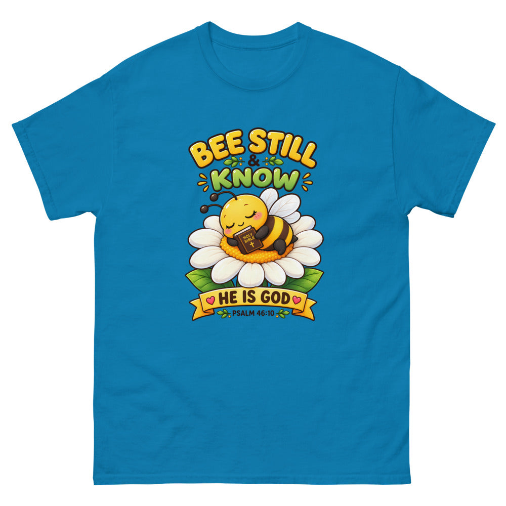 Cartoon bee sleeping on a daisy with a Bible and the words Bee Still And Know on a Sapphire shirt