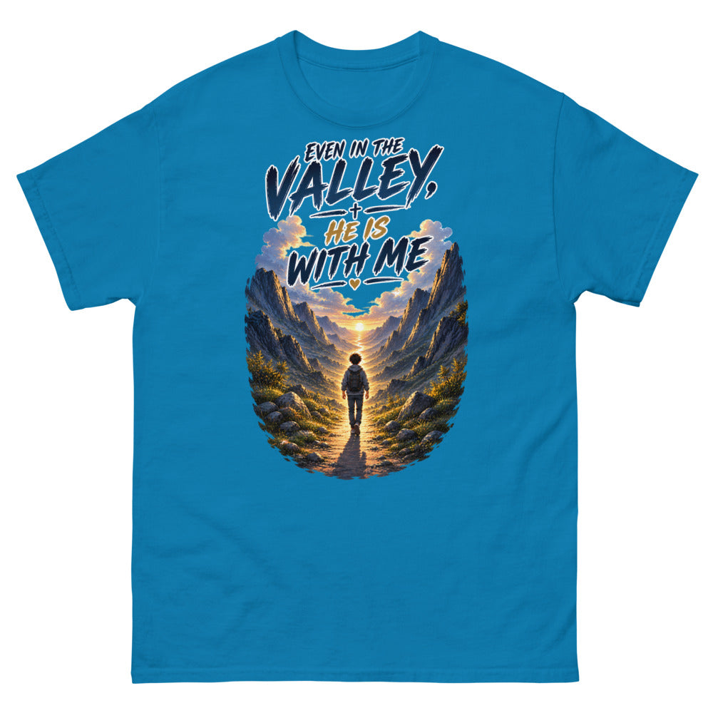 Hiker walking through a mountain valley with the words Even In The Valley He Is With Me on a Sapphire shirt