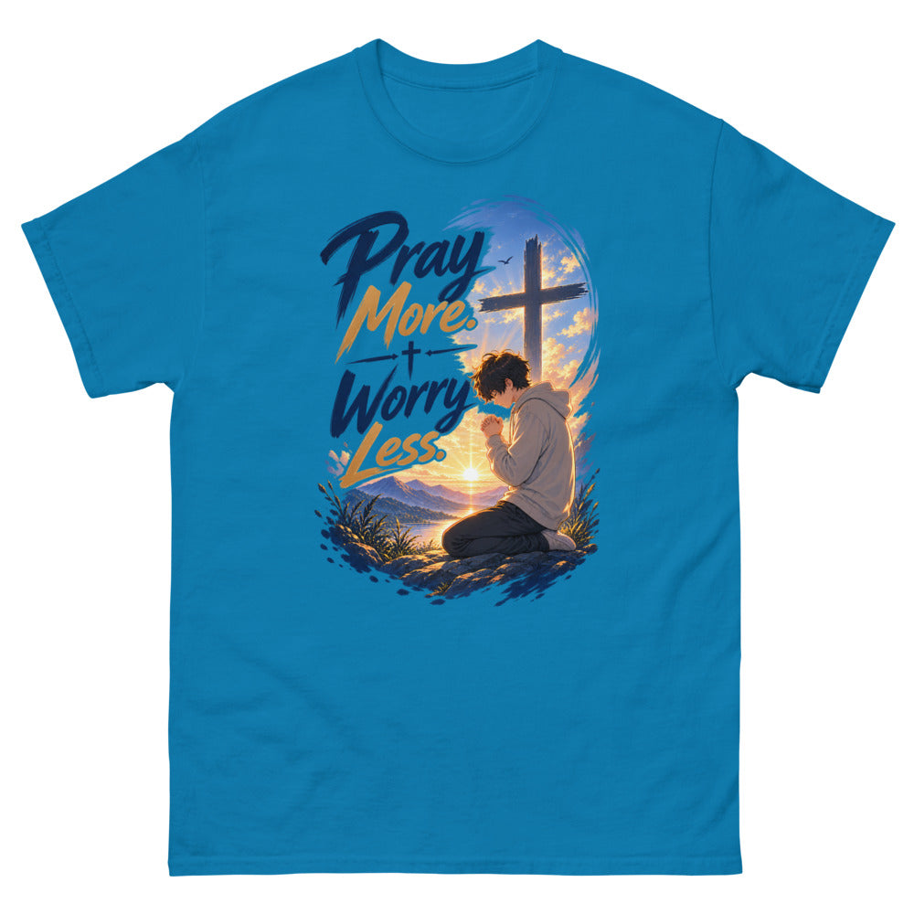 Anime boy kneeling in prayer at sunrise beneath a cross with the words Pray More Worry Less on a Sapphire shirt