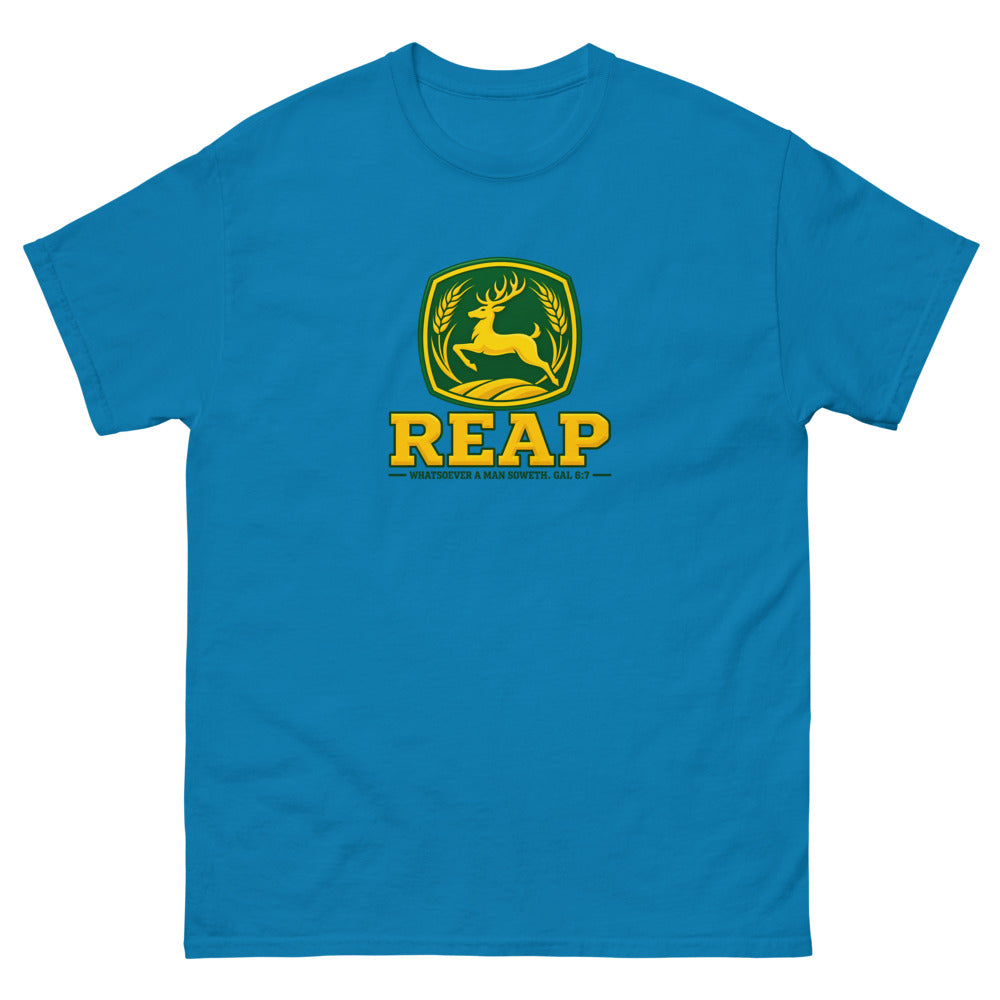 Green and gold crest with a leaping deer and wheat reading Reap, Galatians 6:7 on a Sapphire shirt