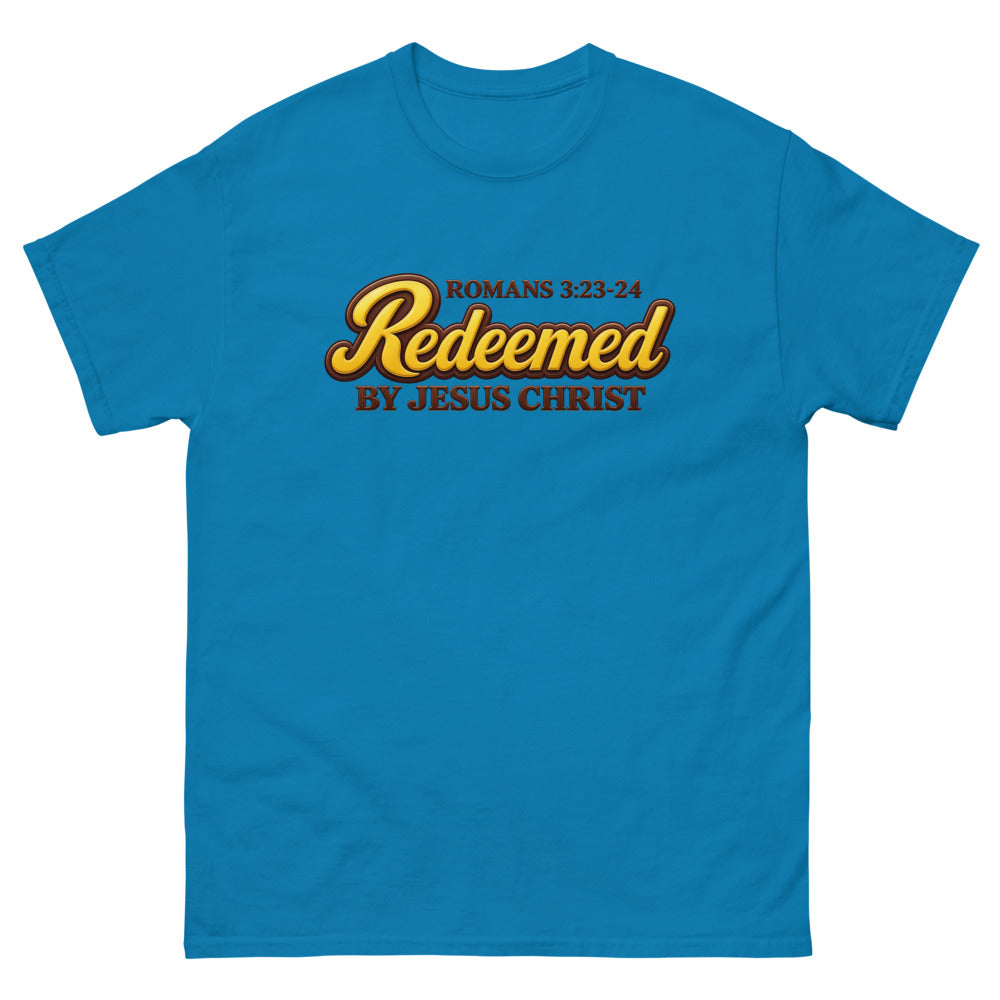 Glossy gold and brown candy script reading Redeemed by Jesus Christ, Romans 3:23-24 on a Sapphire shirt