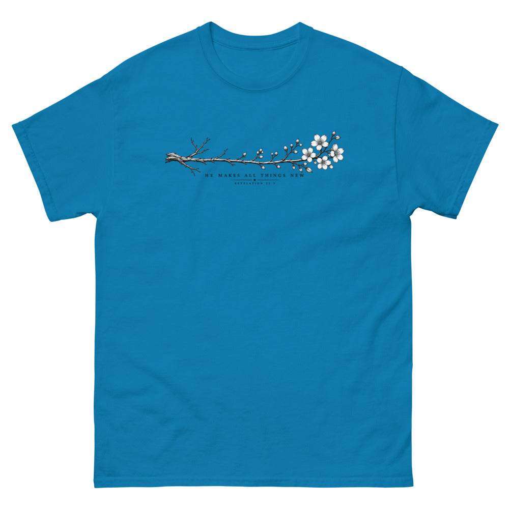 Line art branch flowering from bare to bloom with the words He Makes All Things New on a Sapphire shirt
