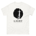 Ink circle with a figure walking toward a blazing cross reading The Light Shines In The Darkness