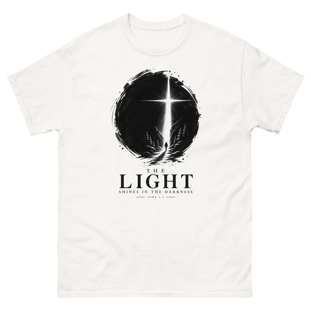 Ink circle with a figure walking toward a blazing cross reading The Light Shines In The Darkness